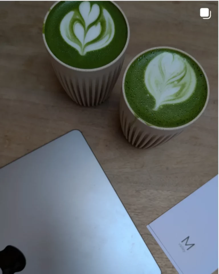 Two matcha lattes on a wooden table with laptop and Marketing Valley card, symbolising the agency’s lifestyle-driven content creation.