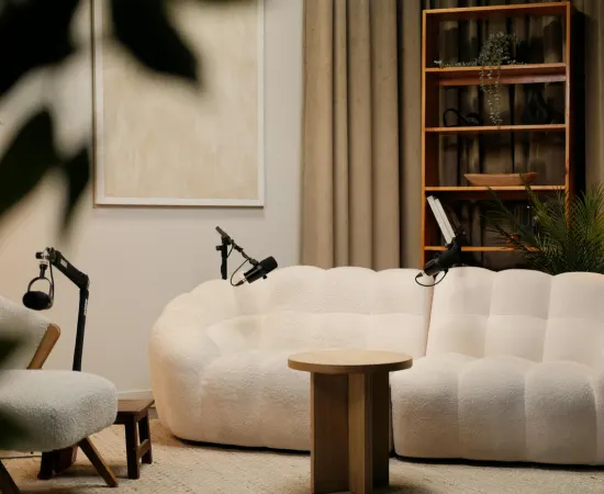 Modern studio setup with sofa, microphones, and styled interior, representing Marketing Valley’s social media content creation.