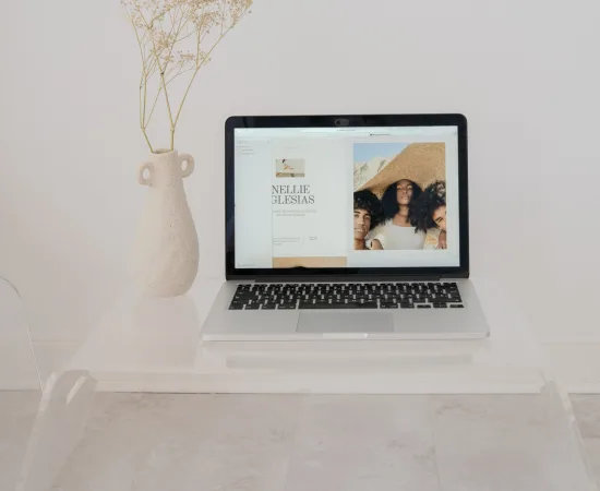 Laptop displaying a lifestyle brand website with neutral décor, representing Marketing Valley’s web design for lifestyle businesses.