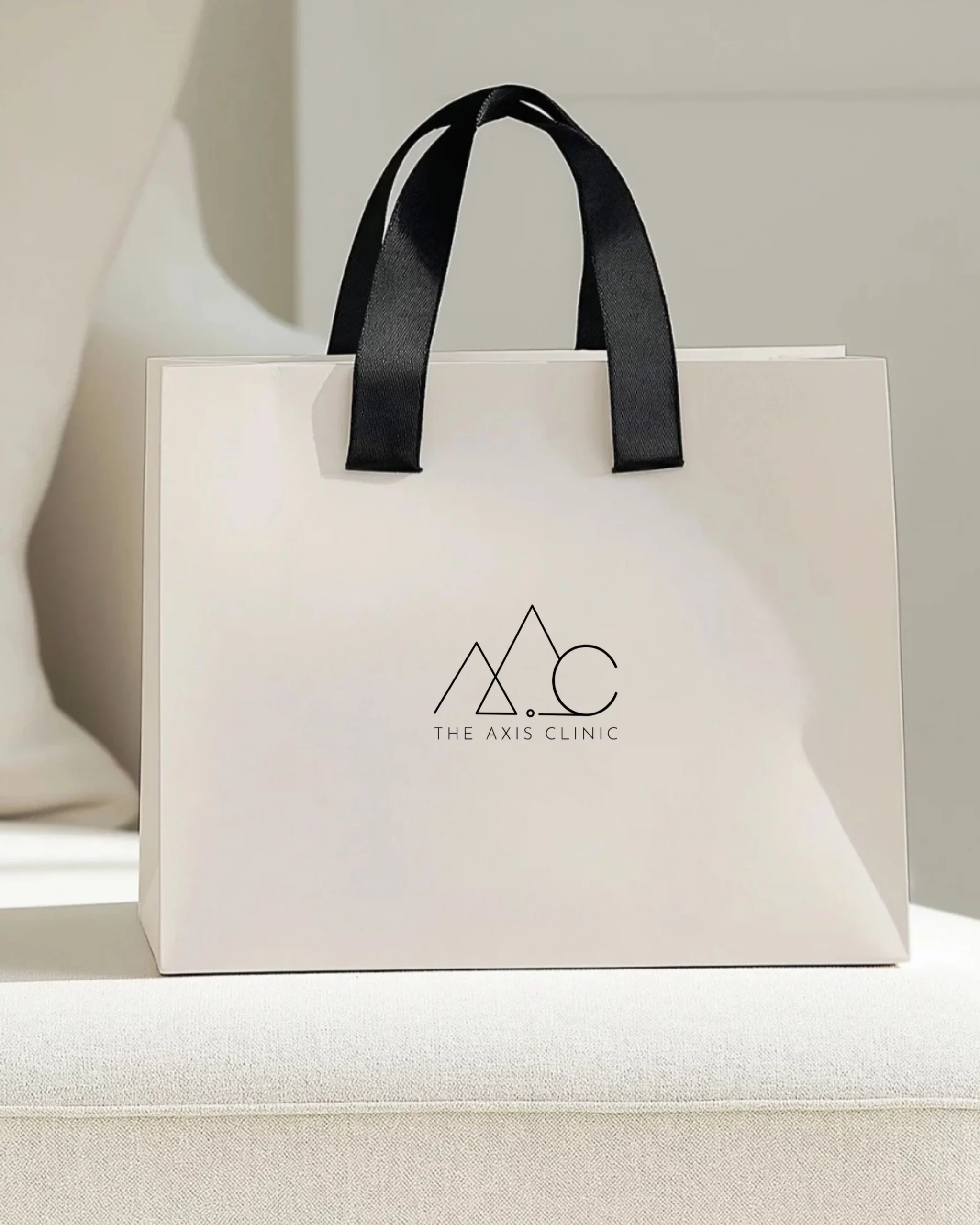 Logo mockup on branded bag for Axis Clinic aesthetic clinic